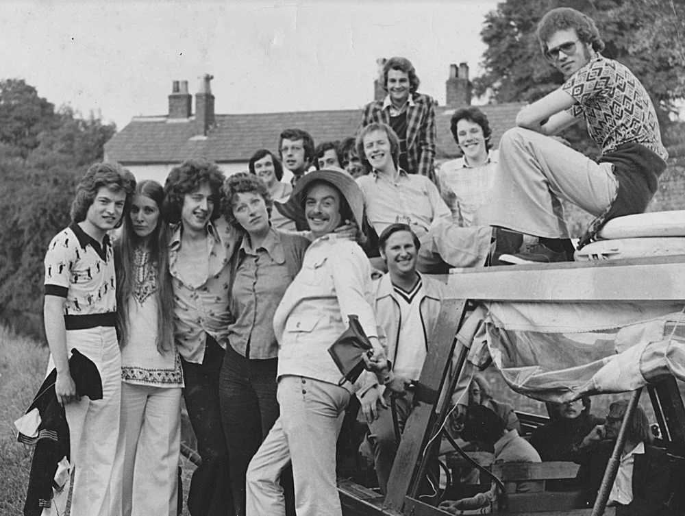 Relaxed group photo of men and women including Paul O'Grady third from left.