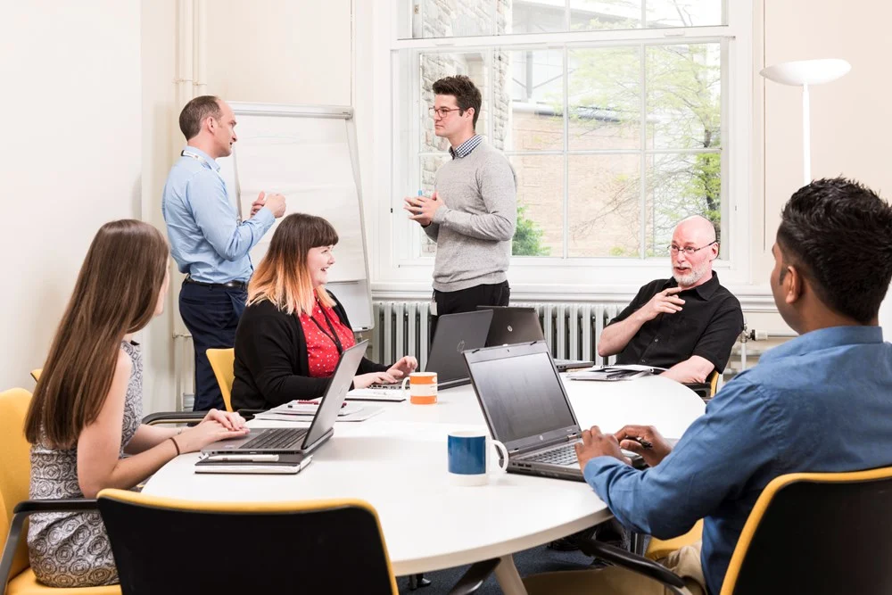 People around a table in an office meeting room