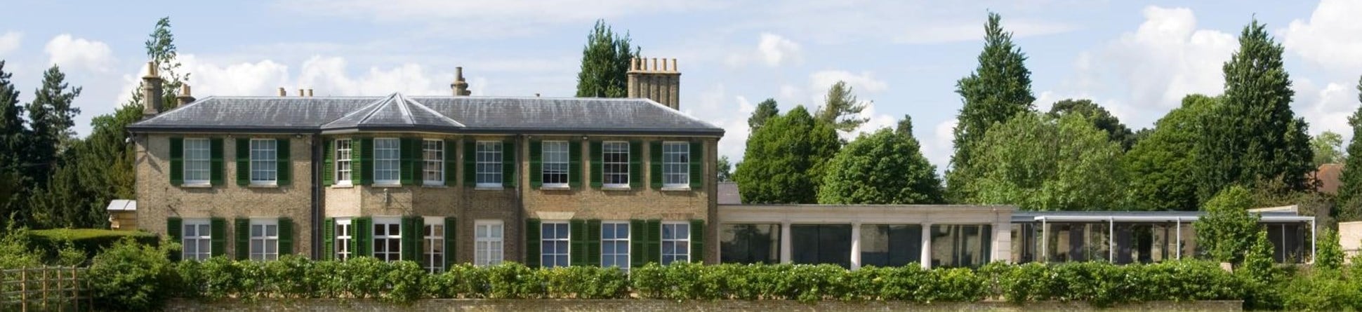 Southerly view of historic office building in direct sunshine.