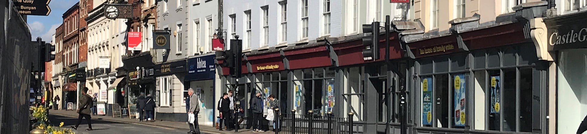 Historic buildings and shop fronts lining the High Street, Bedford.