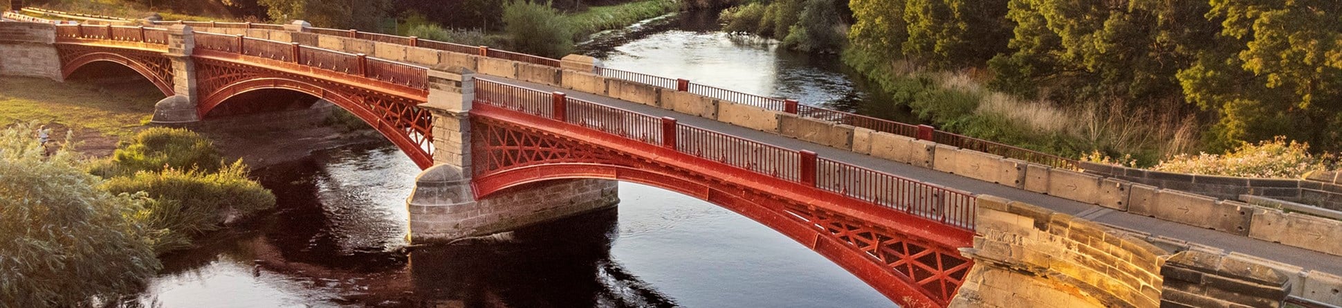 General view of cast iron and rusticated ashlar three segmental arched bridge. 