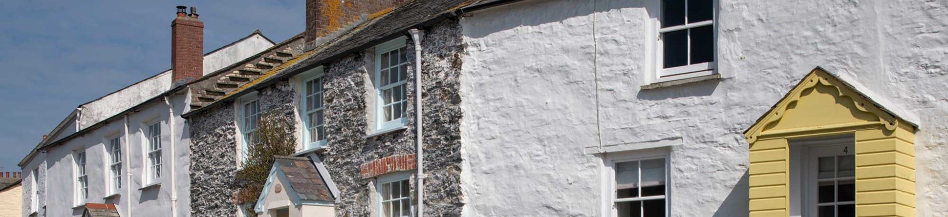 A row of stone cottages with some painted white.