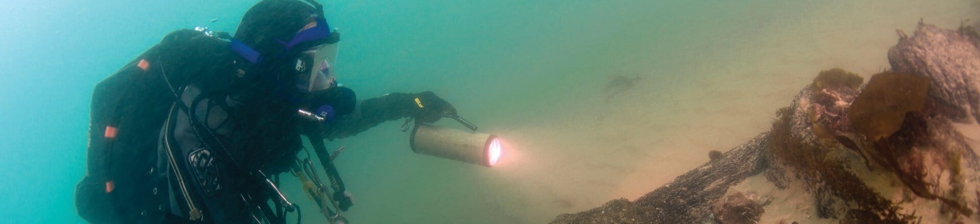 Image of a diver surveying the underwater wreck of the 'Invincible'.