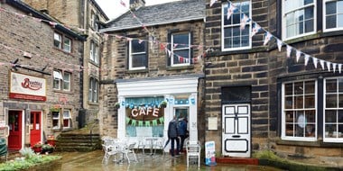 The exterior of a cafe in the rain. 