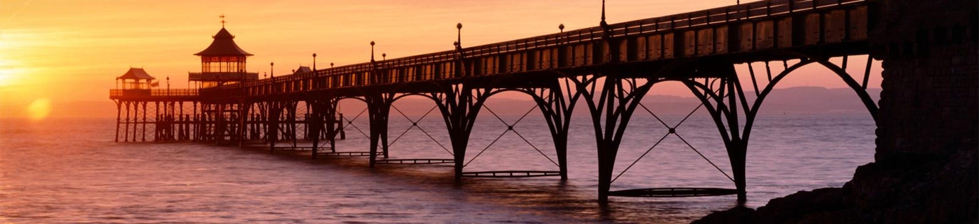 A view of Clevedon pier at sunset.