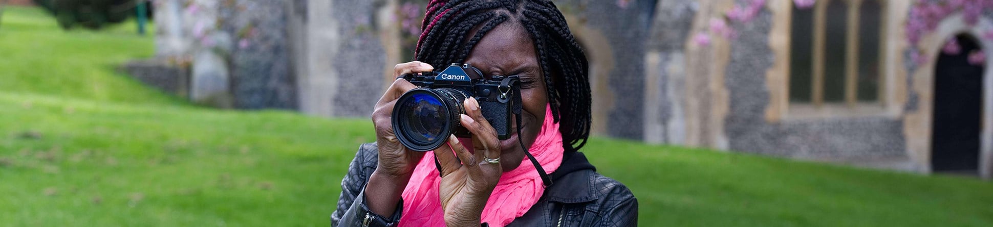 Woman with a camera in a church grounds