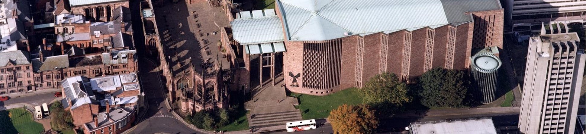 From the air the interior of the old roofless cathedral can be seen to the left of the new cathedral building built in the 1950s.