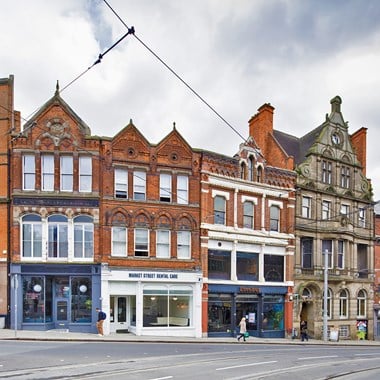 A general view of the exterior of the west front of a building with Dutch gables. 