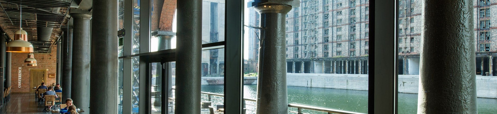 View of a cafe interior and across the dock to other buildings.