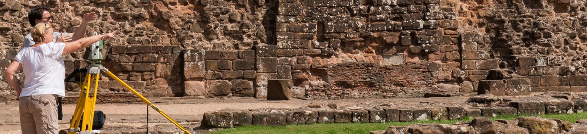 Member of staff teaching surveying at Kenilworth Castle as part of the Historic England Metric Survey School